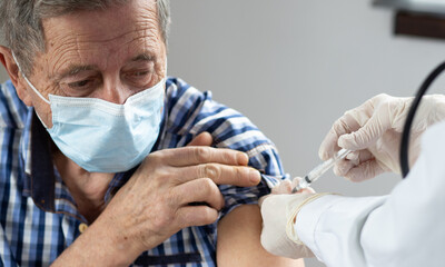 elderly man getting coronavirus vaccine