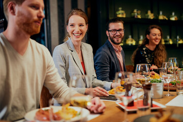 Couple sitting in restaurant, eating diner and drinking wine.