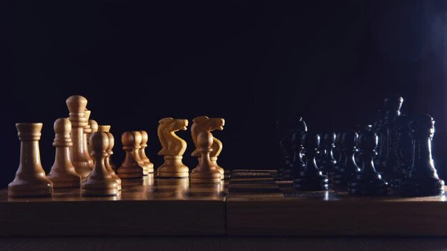 Chess game debut Sicilian defense, time lapse on black background. Front view of a chess game on a retro board from the Soviet Union era