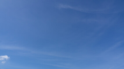 Obraz premium wispy airy transparent clouds in a fan shape. travel over blue sky horizontal left to right. slow-moving clouds in daylight. b-roll timelapse footage of skycaps cloudscape background wallpaper. 