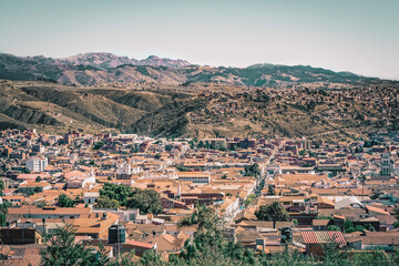 Fototapeta na wymiar Panoramic view of city of Sucre in Bolivia, with colonial style buildings and mountains in the background.