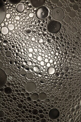 Black and White Oil and Water Abstract Photo. Different sized circles of black, white and grey.