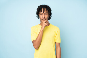 Young african american man isolated on blue background showing a sign of silence gesture putting...