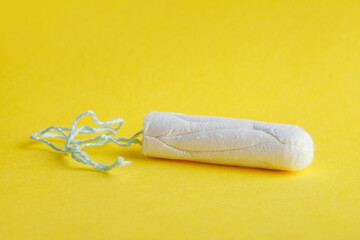 Fototapeta na wymiar menstruation cycle, tampon isolated on yellow