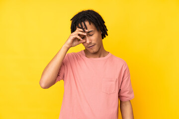 Young african american man isolated on yellow background with tired and sick expression