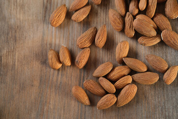 peeled almond nuts are in bulk on a wooden table, edible seed kernels. food concept, confectionery ingredient,nutritional fitness