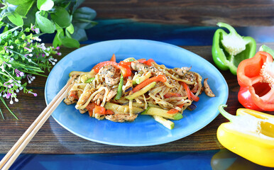 Udon with chicken and vegetables in soy sauce on table. For asian food menu