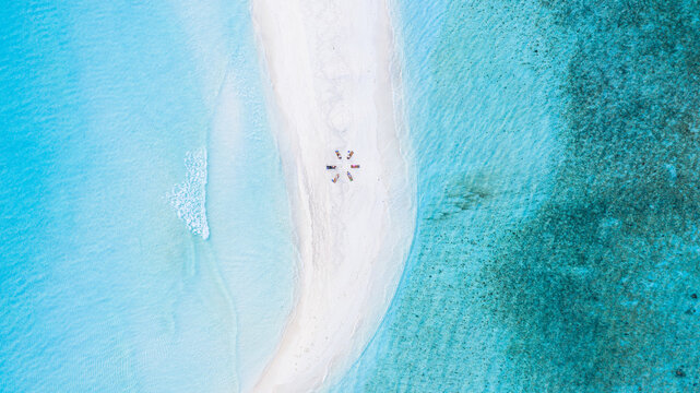 Aerial view of a group of women, doing yoga at a sandbank, Maldives.