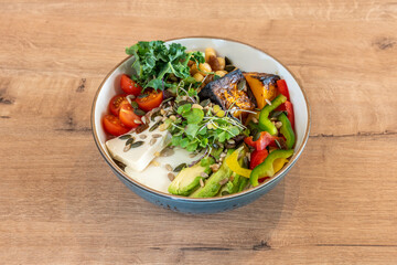 bowl with vegetables and cheese on wooden table