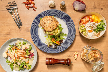 overhead shot of sandwich and salads