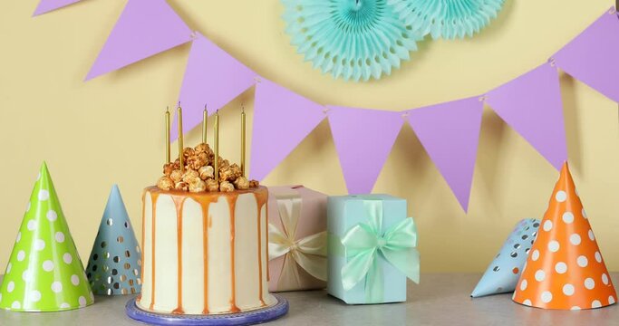 Snuffing out of candles on tasty popcorn cake at Birthday party