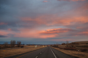 Beautiful sky at sunset dark blue and bright orange clouds over the highway
