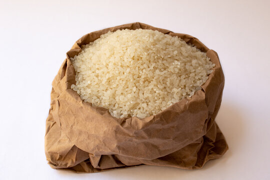 Paper bag with arboreous rice. Isolated on white background