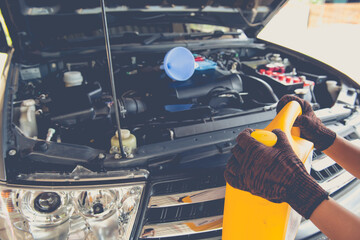 Mechanic replacing motor oil service ,car maintenance 