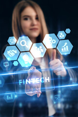 Business, Technology, Internet and network concept. Young businessman working on a virtual screen of the future and sees the inscription: Fintech
