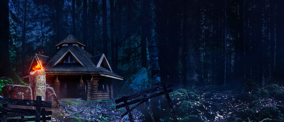 Horror background image of fantasy witch house in night woods with magic totem with symbols. © breakermaximus