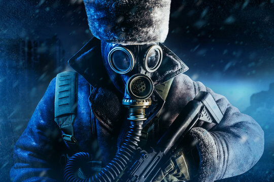 Photo Of Winter Stalker Soldier In Fur Coat, Hat Standing With Pouch Vest, Gas Soviet Mask And Rifle In Stormy Snowfall Weather.