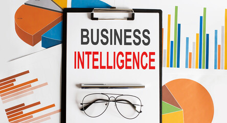Business intelligence text . Conceptual background with chart ,papers, pen and glasses, business