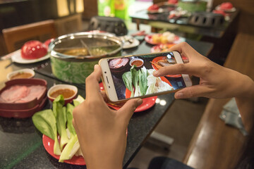 Teenagers hands taking picture of food by mobile phone