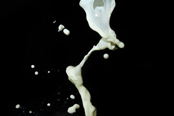 Milk splash on black background