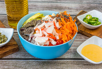 Hawaiian salmon, tuna and shrimp poke bowls with seaweed, avocado, mango, pickled ginger, sesame seeds. 