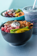 Hawaiian salmon, tuna and shrimp poke bowls with seaweed, avocado, mango, pickled ginger, sesame seeds. 