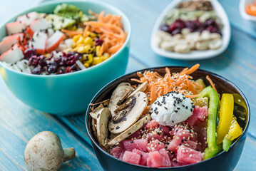 Hawaiian salmon, tuna and shrimp poke bowls with seaweed, avocado, mango, pickled ginger, sesame seeds. 