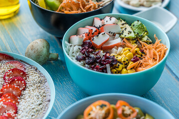 Hawaiian salmon, tuna and shrimp poke bowls with seaweed, avocado, mango, pickled ginger, sesame seeds. 