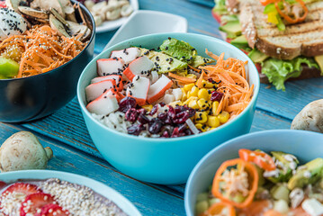 Hawaiian salmon, tuna and shrimp poke bowls with seaweed, avocado, mango, pickled ginger, sesame seeds. 
