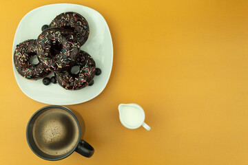 Fresh and crispy donut and coffee with milk