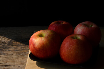 Fresh apple group on wooden block in the light of day