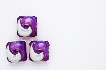 A picture of 3 in 1 laundry detergent pod on isolated white background. Economic and environment friendly for clothes washing