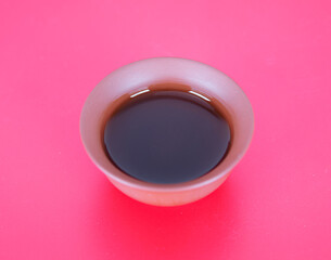 A bowl of tea on a red background