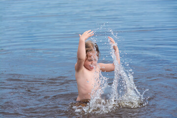 A girl plays in the water on a hot sunny day.