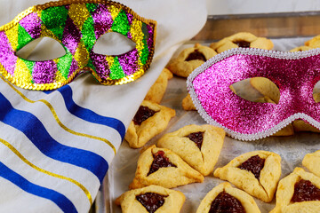 Traditional hamantaschen cookies with jam, tallit and mask.