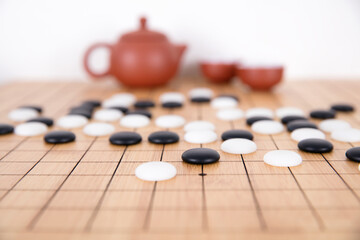Chess pieces and tea set background on chess board