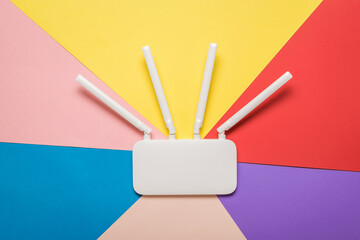Wi-Fi router with external antennas on a multi-colored background.