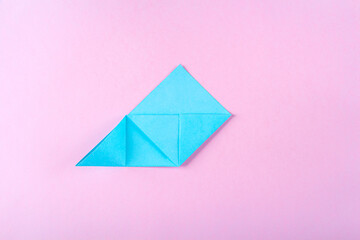 DIY and kid's creativity, origami. Step by step instruction: how to make bookmark easter bunny. Step 7 Bend left corner up, and turning down its upper part inward. Easter craft.