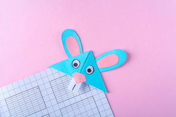 DIY and kid's creativity, origami. Step by step instruction: how to make bookmark easter bunny. Step 9 Finished bookmark for book, funny rabbit. Easter craft.