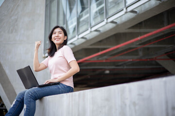Fototapeta premium Asian woman checking work through notebook