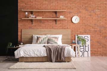 Interior of bedroom with brick wall