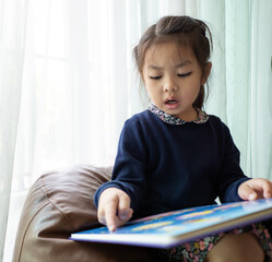 Naklejka premium Asian children girl reading book 
