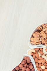 Different nuts and almonds as source vitamins and minerals, place for text or inscription