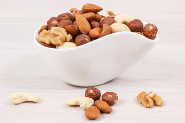Fototapeta na wymiar Various nuts and almonds in bowls, healthy nutrition and lifestyle concept