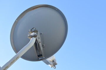 View of satellite dish with blue sky in background