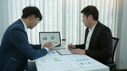 Group of business people analysis summary graph reports of business operating expenses and work data about the company's financial statements.