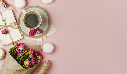 Cup of coffee and Bouquet of spring flowers on trending pink paper.The concept of valentine's day and women's day.Flat lay, top view with copy space.