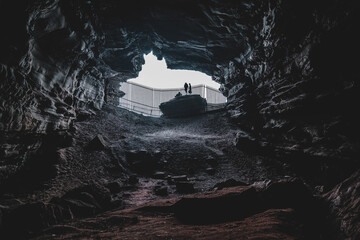 Silhouette of People Standing On Rock In Cave.Outdoor Adventure.