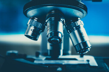 scientific microscope for biology research in laboratory, medicine microbiology or biotechnology technology equipment, coronavirus covid-19 vaccine development