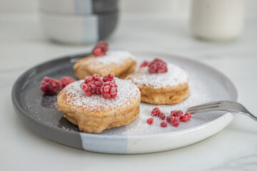 Tasty american pancakes with raspberries on a table